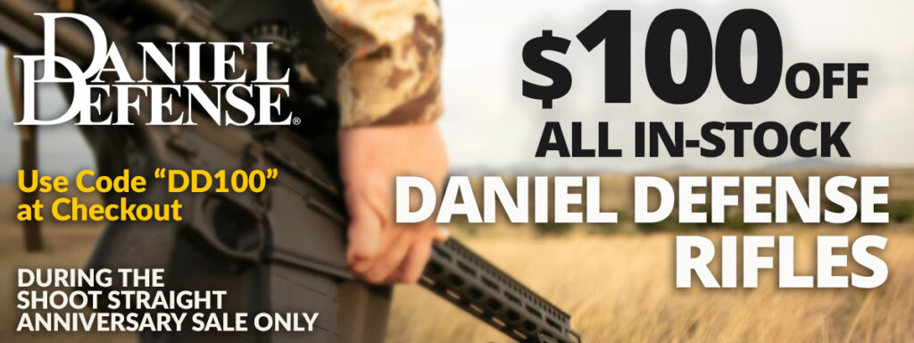 Lower side profile of a man holding a Daniel Defense rifle by his side in his right hand in a large open field overlayed with promotional text.